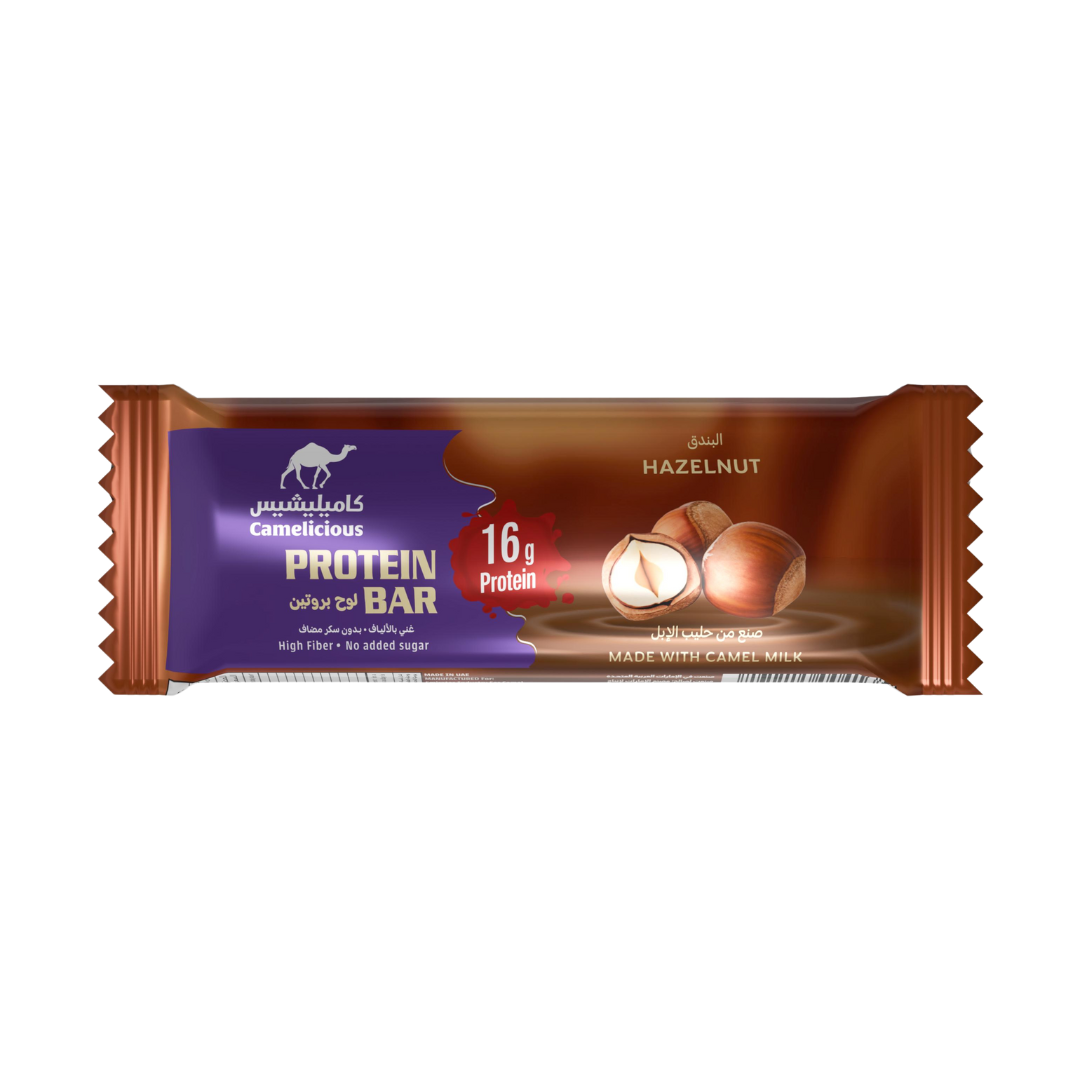 Camelicious Hazelnut Protein Bar 60g made with camel milk, featuring 16g of protein, high fiber, and no added sugar, in brown and purple packaging with hazelnut imagery.