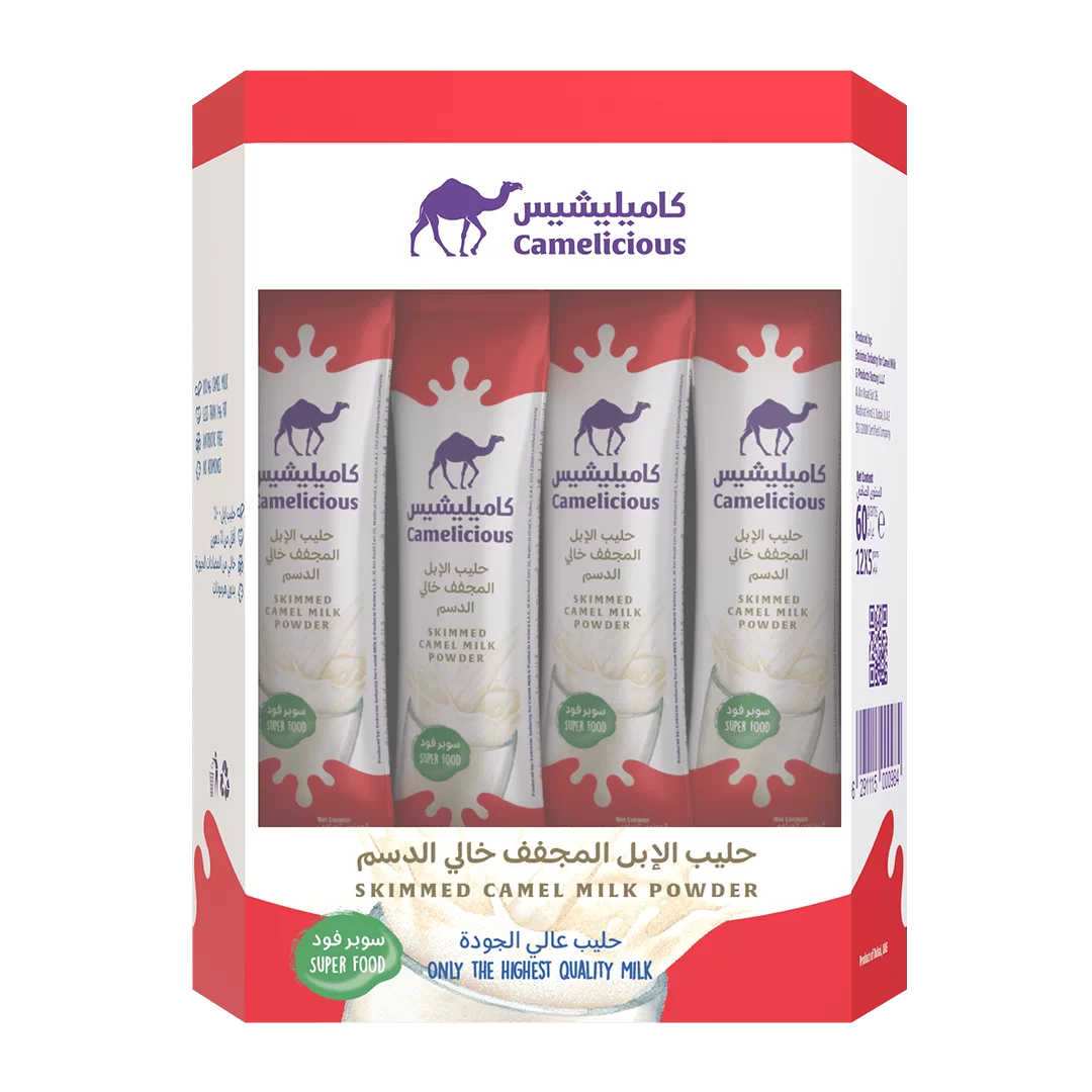 Front view of Camelicious Skimmed Camel Milk Powder box containing 12 sachets, featuring red and white packaging with the brand logo and milk splash design.