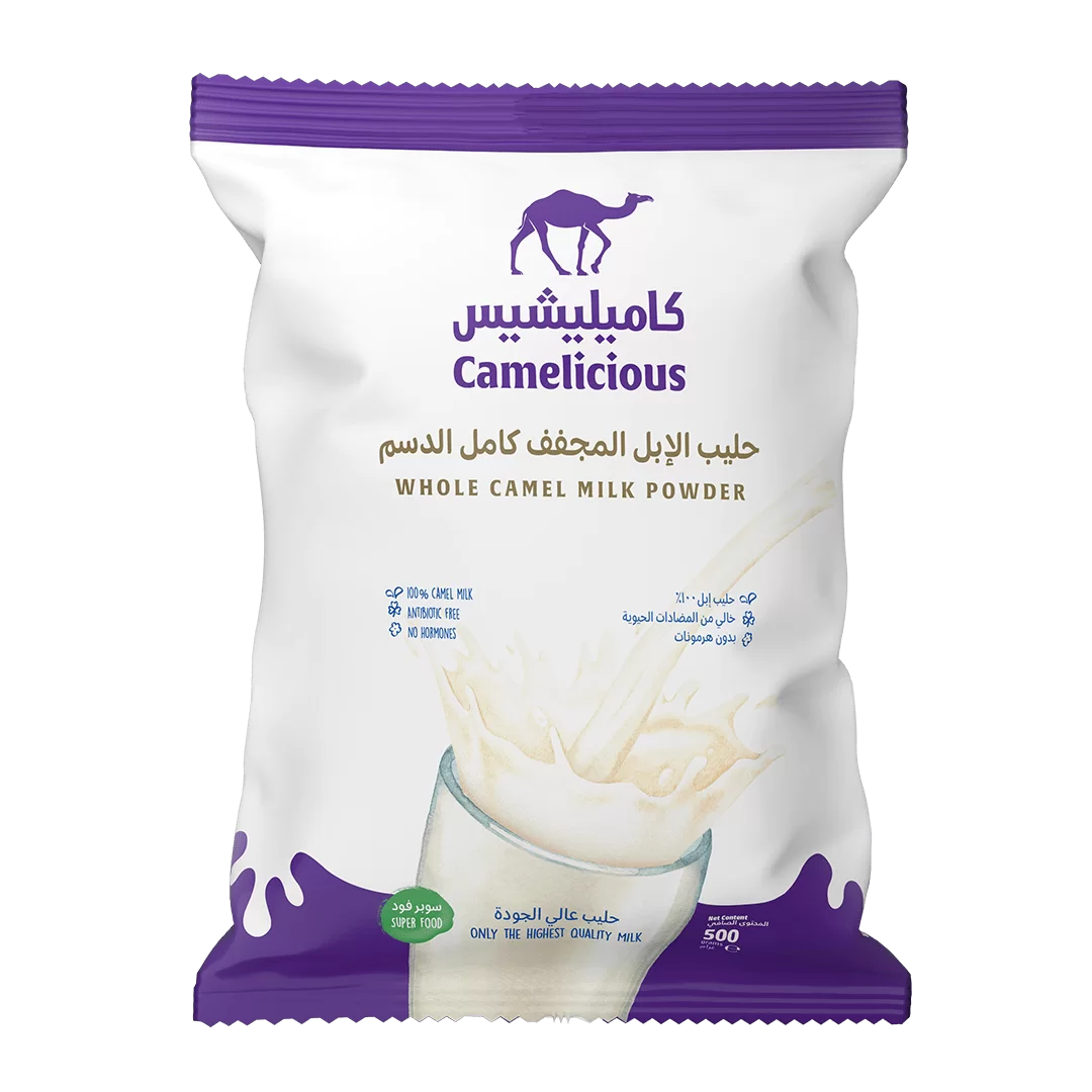 Front packaging of Camelicious Whole Camel Milk Powder 500g showing the brand logo, product name in Arabic and English, and an image of milk splashing into a glass.